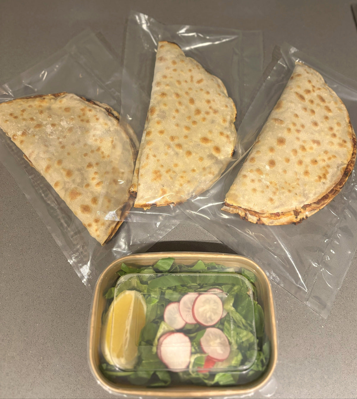 Three packs of freezer-ready lahmacun